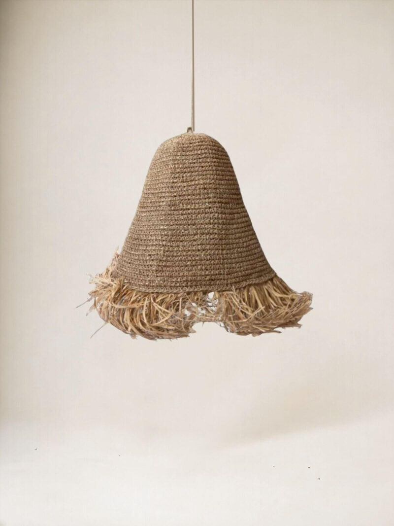 Lampa z frędzlami wisząca Flecos na tle jasnej ściany.